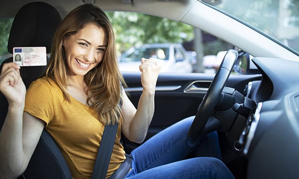 Young woman excited about receiving her driver's license