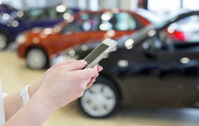 using smartphone at auto dealer