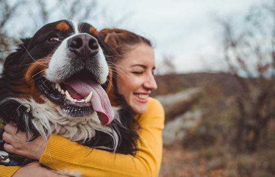 woman hugging dog