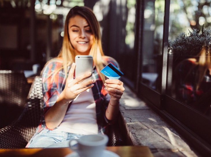 woman online shopping at cafe