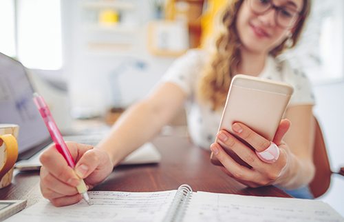 woman writing in notepad